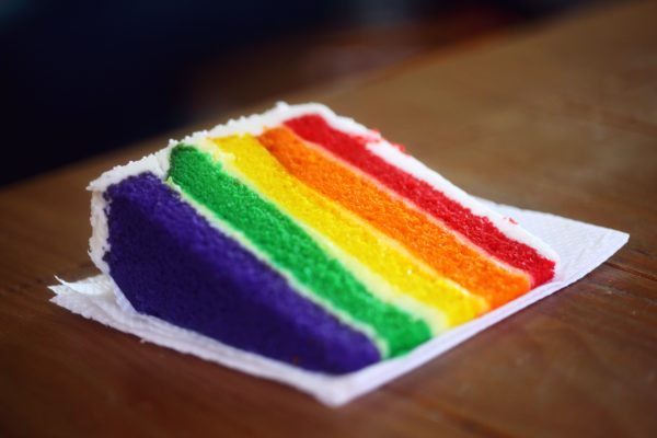 Slice of cake with multi-colored layers symbolizing standing out from the crow with good SEO.